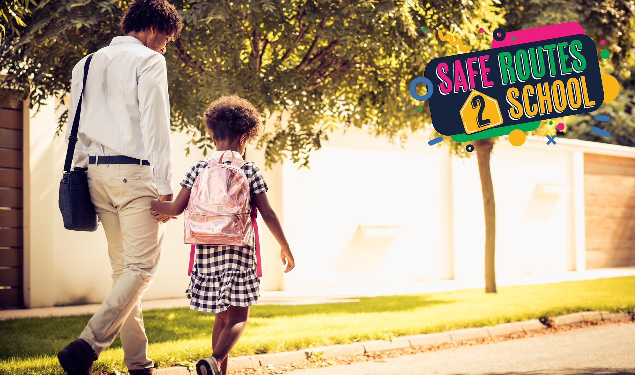 Parent and child holding hands and walking