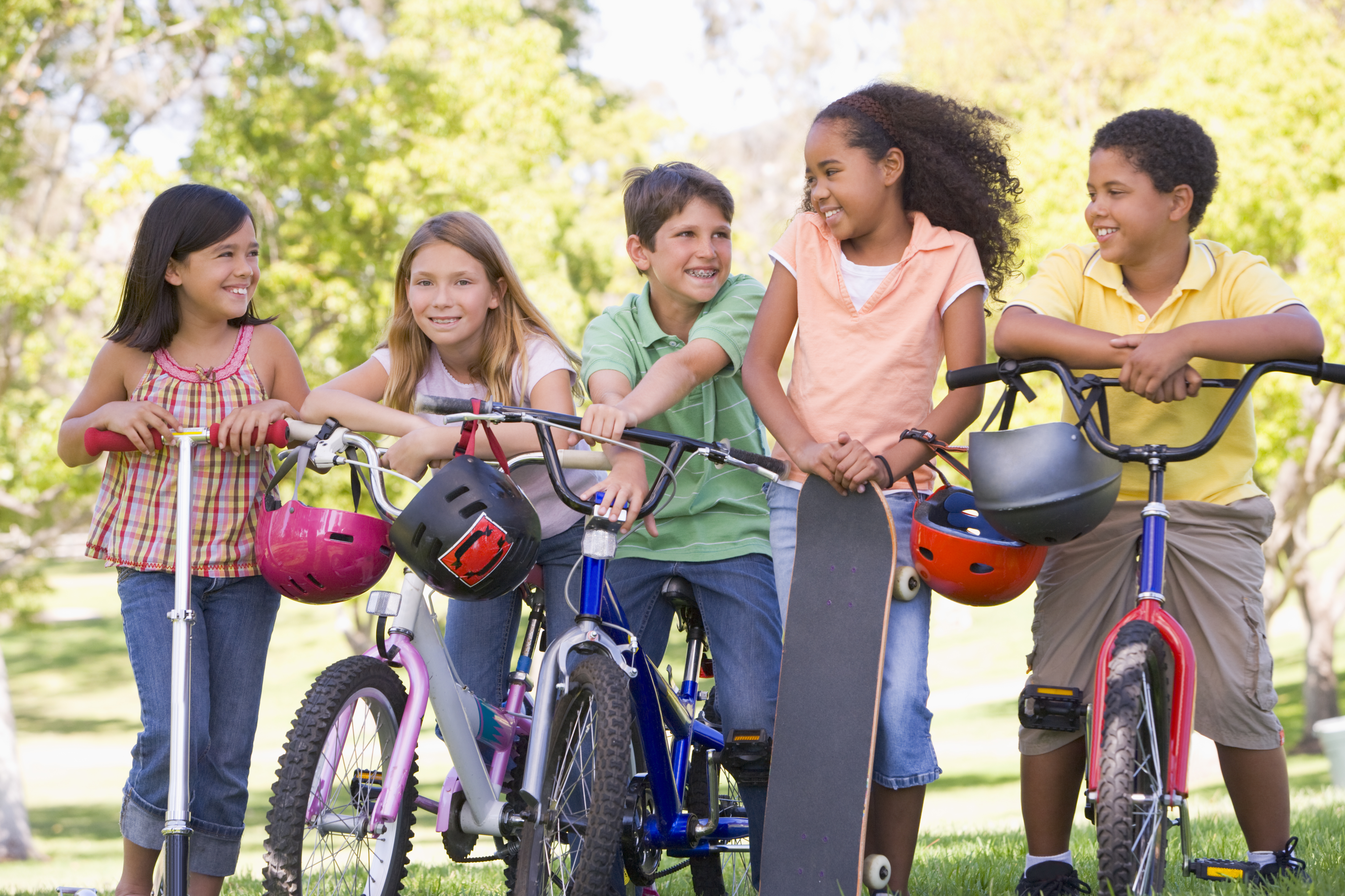 Children on bikes and scooters