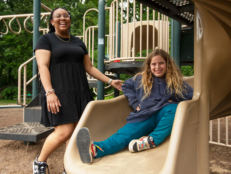 Jaliah Singleton with student on sliding board