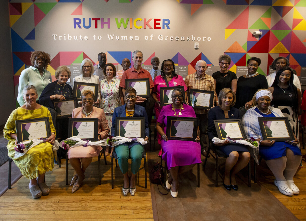 Group posing holding certificates