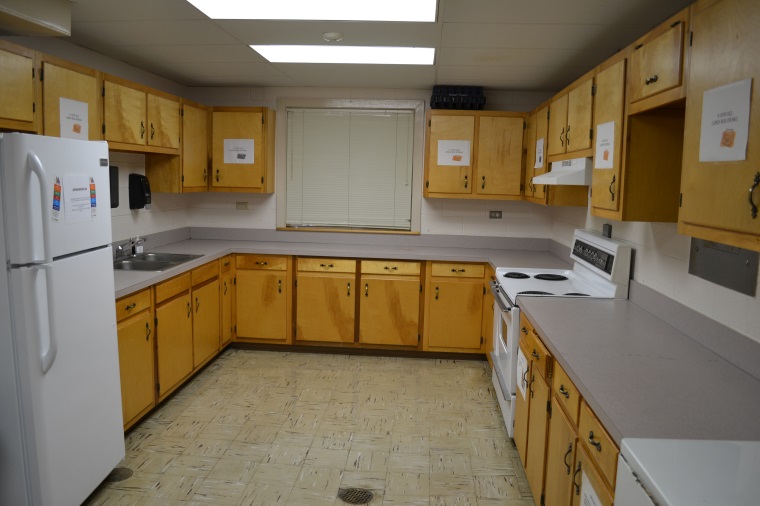 Kitchen with stove, sink and refrigerator